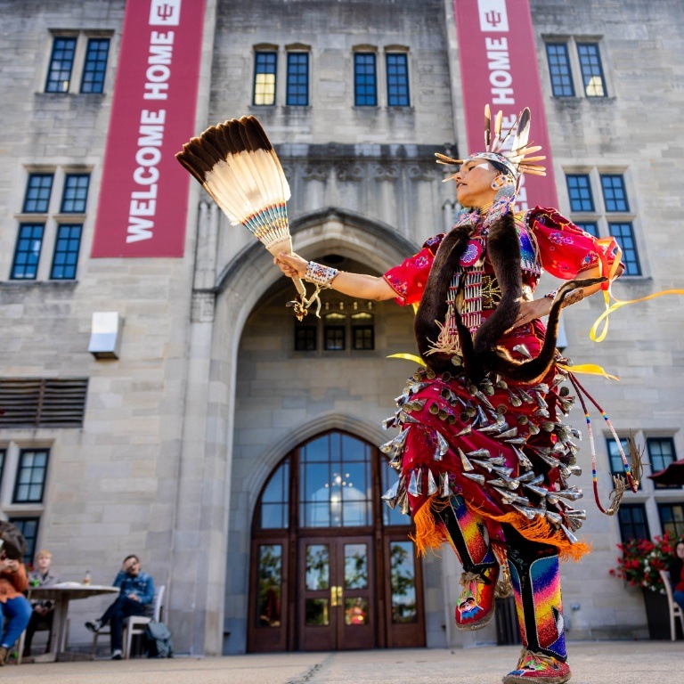 A woman dancing outside of Indiana Memorial Union for Indigenous Peoples Day.